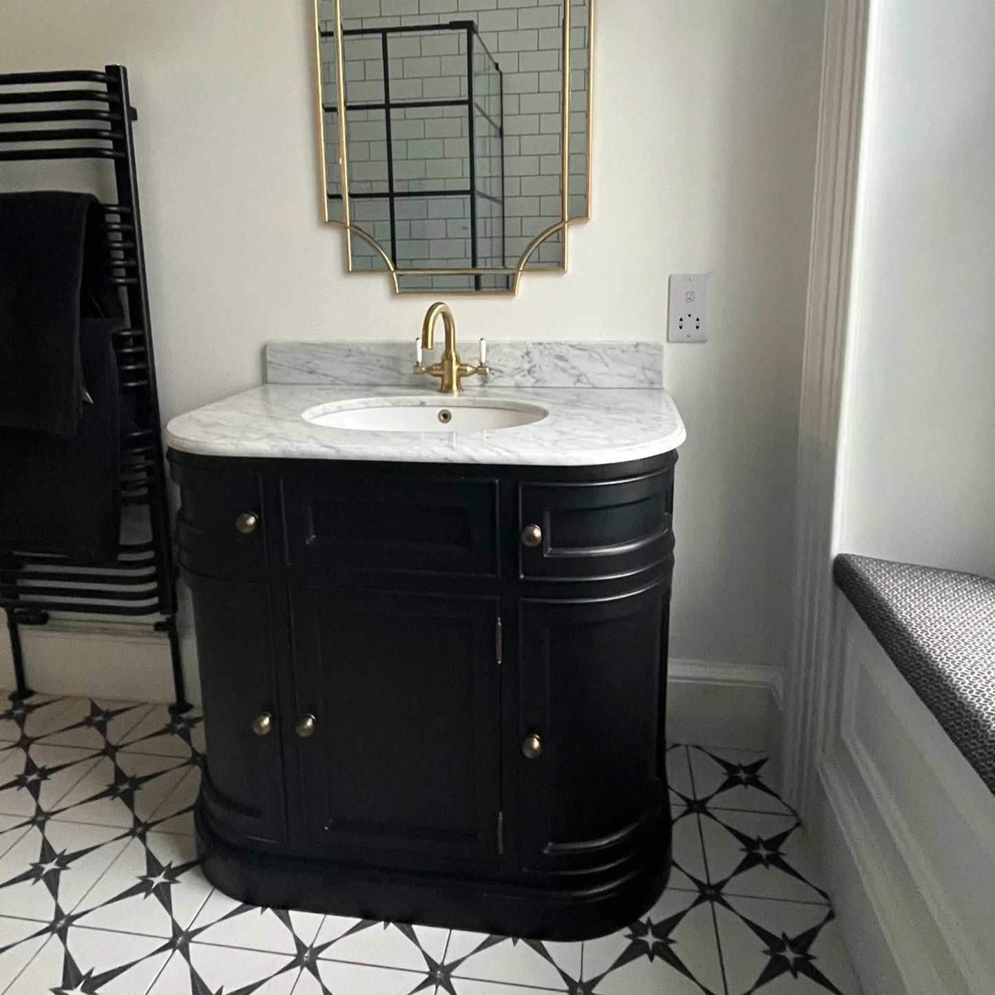 black curved single sink vanity unit