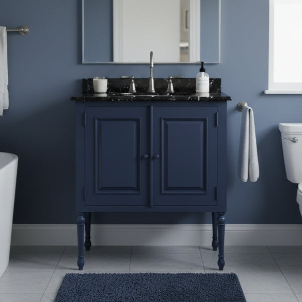 Bathroom with a navy blue vanity unit, sink, and mirror against a blue wall.