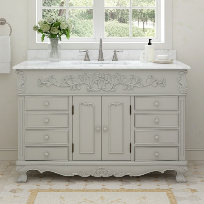 Decorative bathroom vanity with marble countertop and sink in a bright room.