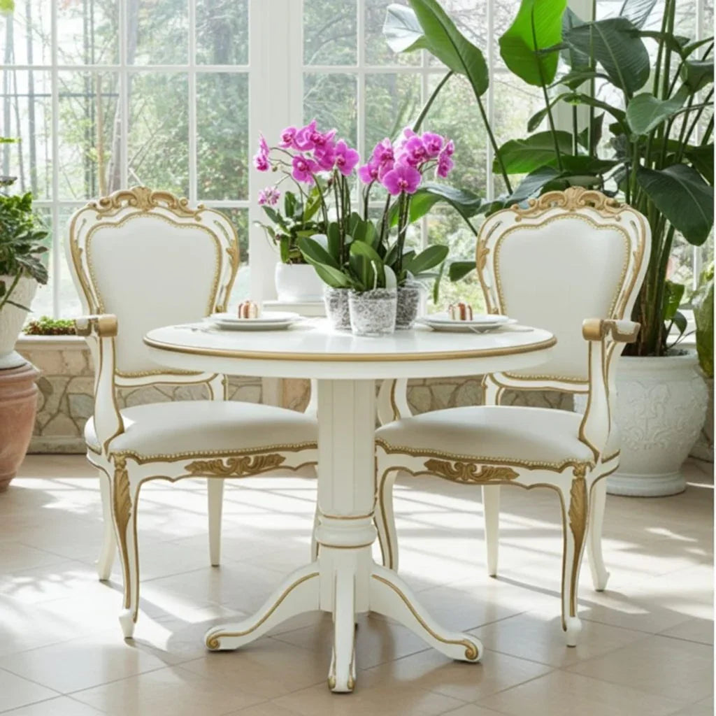 Dining table with chairs and a vase of flowers in a bright room.