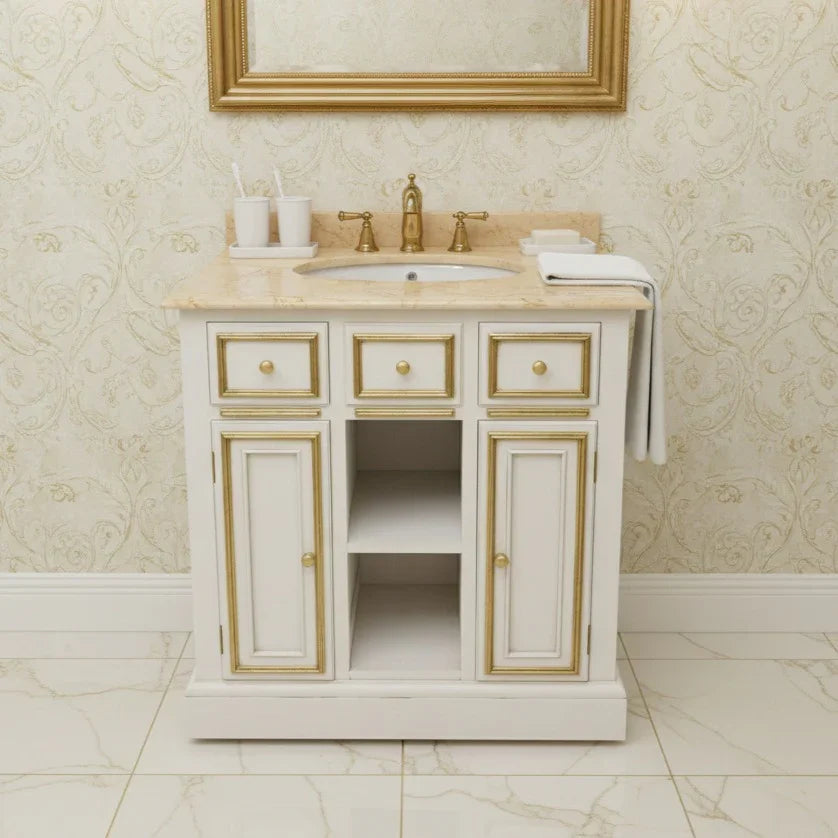 Bathroom vanity with marble countertop and gold accents in a bathroom setting.