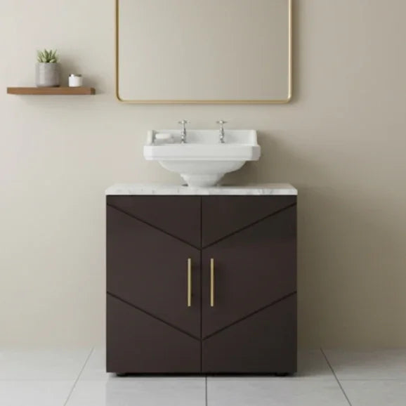 Bathroom vanity with white sink and dark brown cabinet against a beige wall.