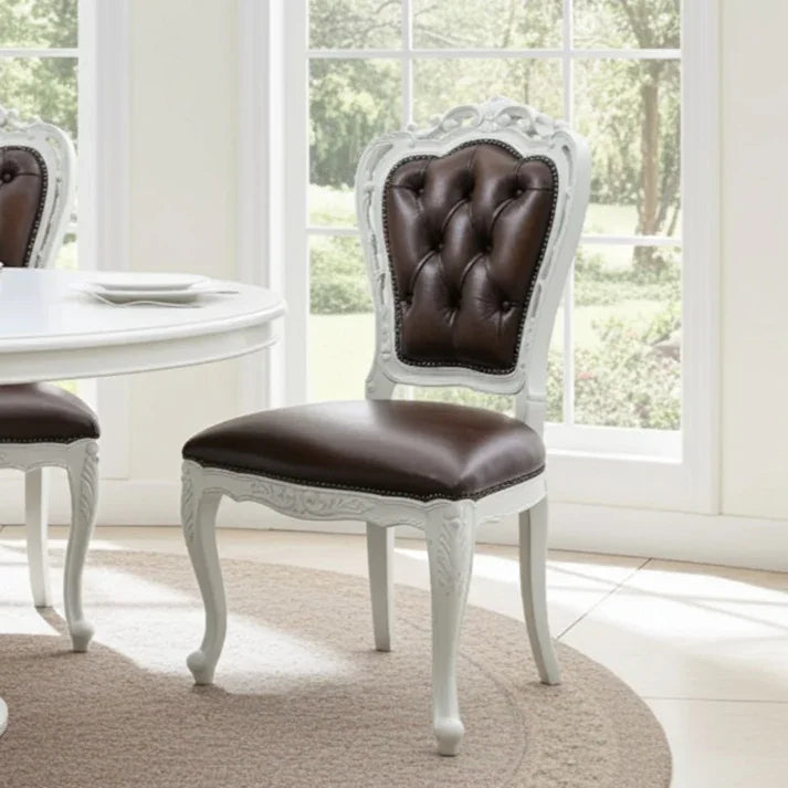 Dining room with a chair featuring a brown leather seat and backrest, white frame, and decorative elements.