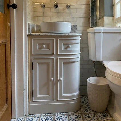 Bathroom with white vanity, toilet, and shower area.