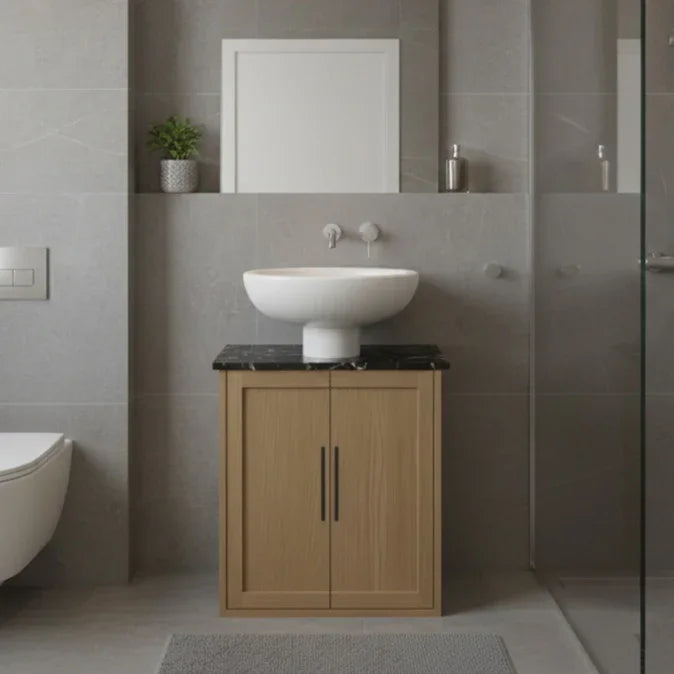 Bathroom with wooden vanity, white sink, and gray tiles