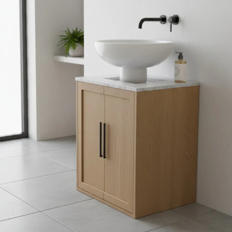 Bathroom vanity with wooden cabinet, white sink, and black faucet.