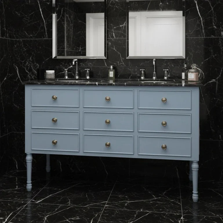 Blue vanity with marble countertop and black marble walls