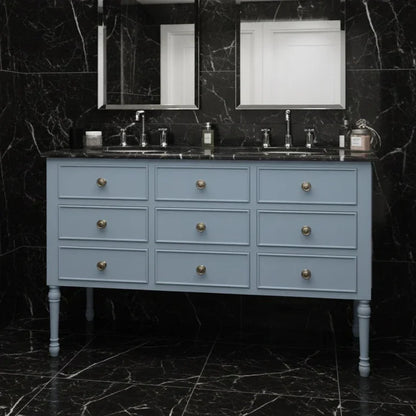 Blue vanity with marble countertop and black marble walls