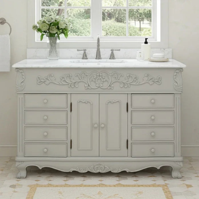 Decorative bathroom vanity with marble countertop and sink in a bright room.