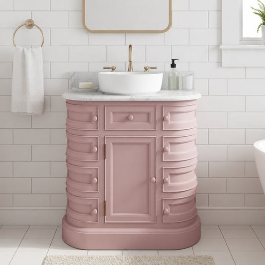 Pink bathroom vanity with white sink and marble countertop in a tiled bathroom.