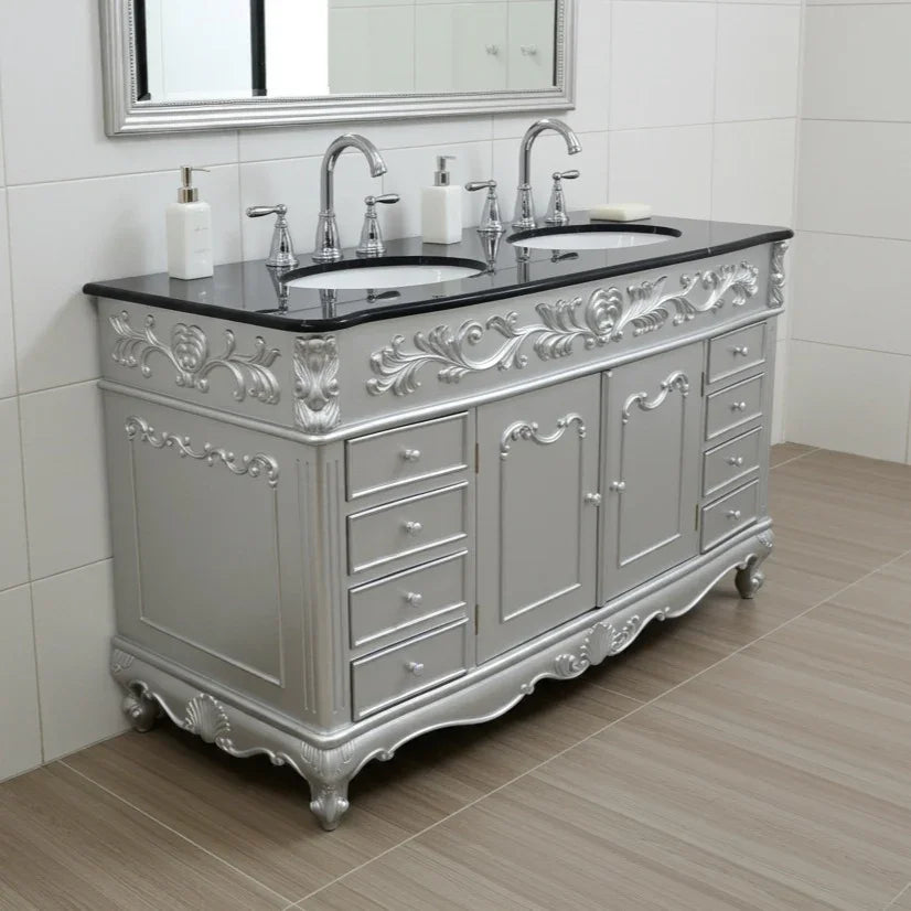 Silver bathroom vanity with black countertop and mirror in a tiled bathroom.