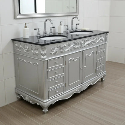 Silver bathroom vanity with black countertop and mirror in a tiled bathroom.