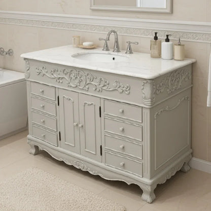 Vintage-style bathroom vanity with marble countertop and faucet in a bathroom setting.