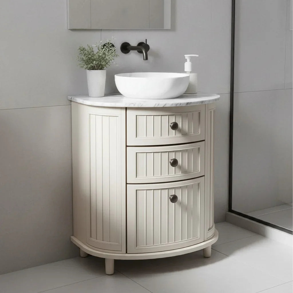 Bathroom vanity with white sink and marble countertop in a modern bathroom setting.