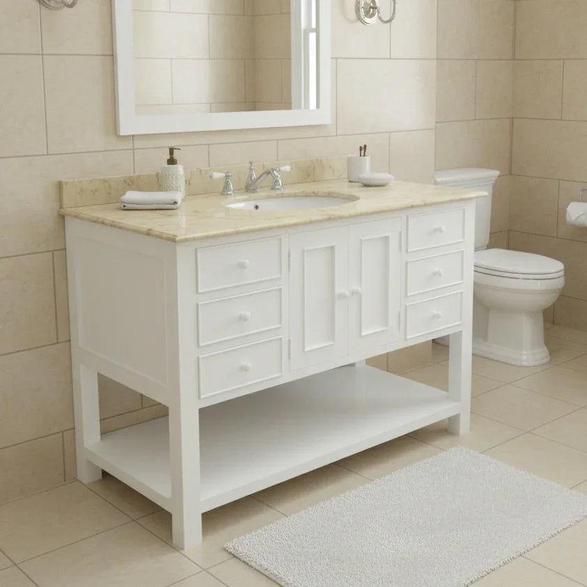 Bathroom with white vanity, sink, and toilet against beige tiled walls.