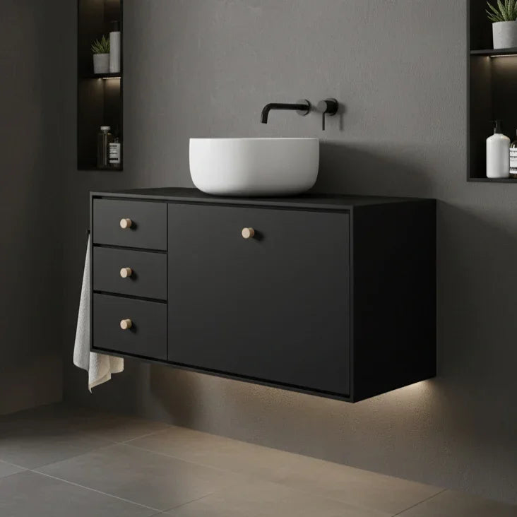 Bathroom vanity with a white sink against a dark gray wall.