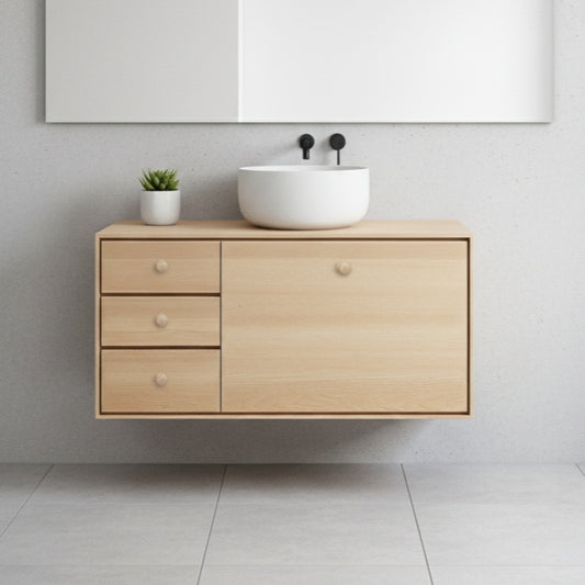 Bathroom vanity with wooden cabinet, white sink, and decorative elements on a light gray wall.