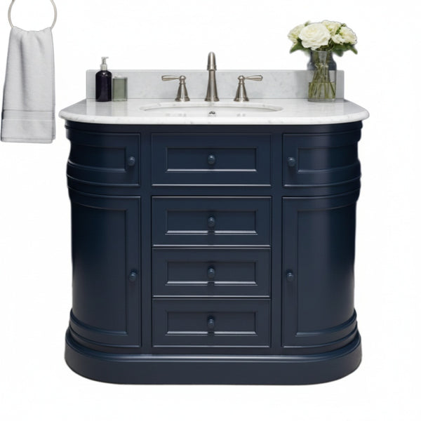 Navy blue bathroom vanity with white countertop, sink, and accessories on a white background