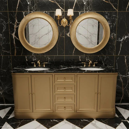 Bathroom vanity with gold fixtures and round mirrors against a marble wall.