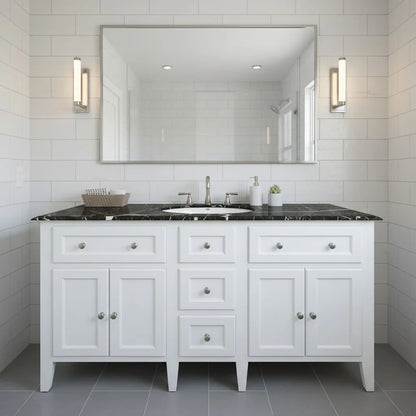 Bathroom vanity with black countertop, mirror, and wall lights.
