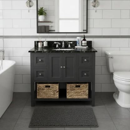 Bathroom with dark gray vanity, white tiles, and a toilet.
