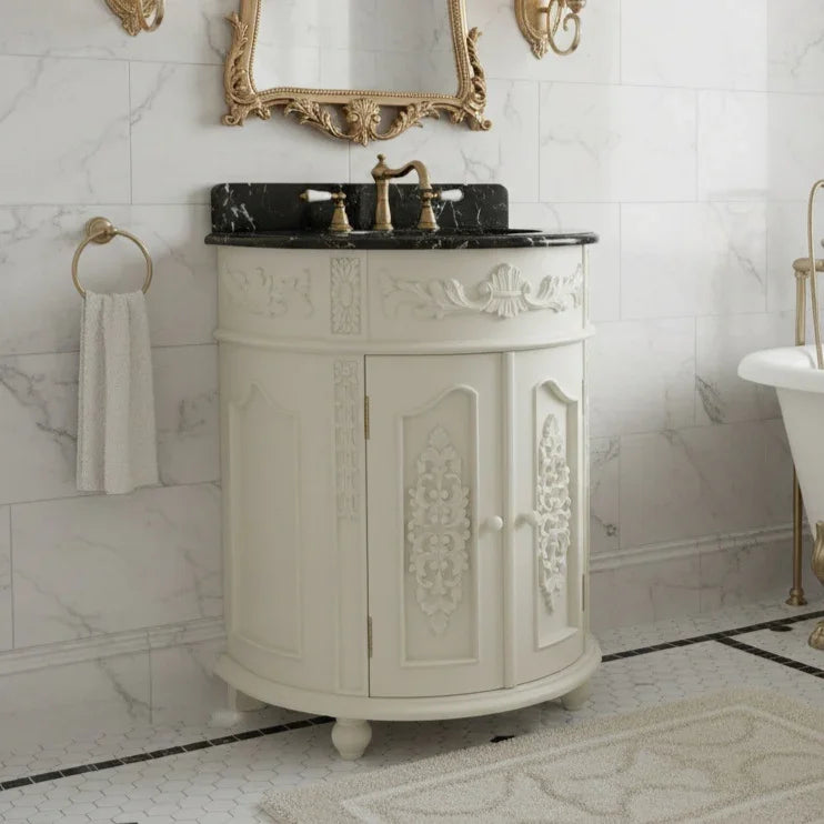 Decorative bathroom vanity with marble countertop and ornate mirror in a marble-walled bathroom.