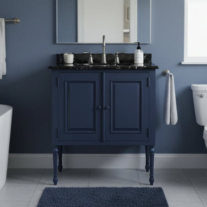 Bathroom with a navy blue vanity unit, sink, and mirror against a blue wall.