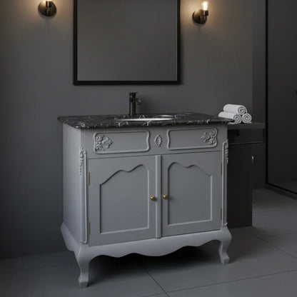 Gray bathroom vanity with marble countertop and mirror in a dimly lit room.