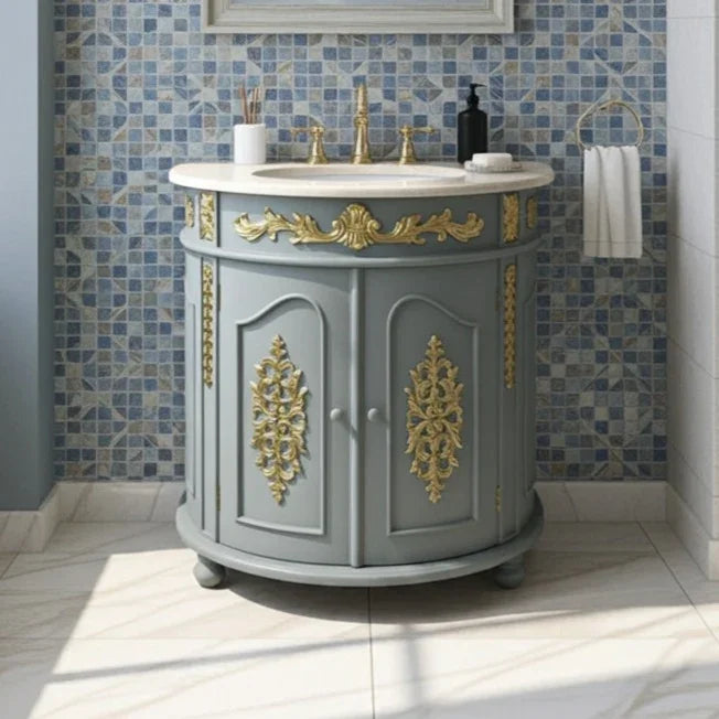 Gray bathroom vanity with gold decorative elements against a blue tiled wall.