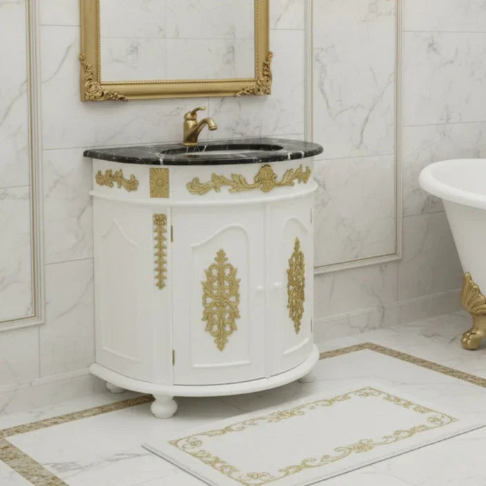 Decorative bathroom vanity with gold accents in a marble bathroom setting.