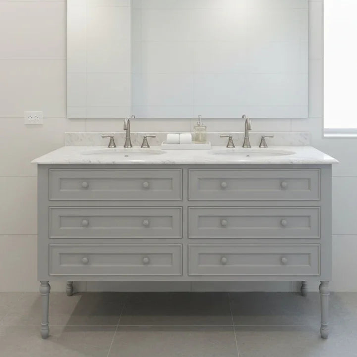 Gray bathroom vanity with white countertop and marble-like finish in a modern bathroom setting.