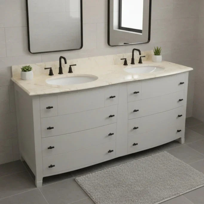 Bathroom vanity with double sink and marble countertop in a tiled bathroom.