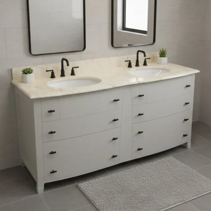 Bathroom vanity with double sink and marble countertop in a tiled bathroom.