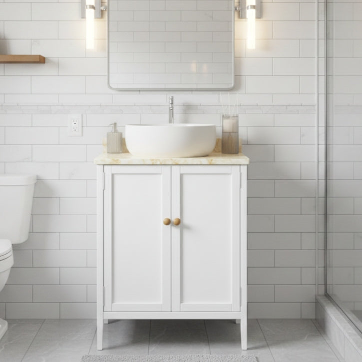 Bathroom with white vanity, sink, and mirror against a tiled wall.