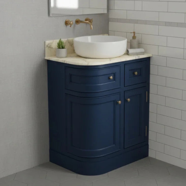 Bathroom vanity with blue cabinet, white sink, and gold fixtures.