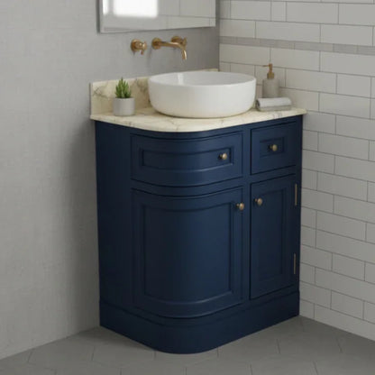 Bathroom vanity with blue cabinet, white sink, and gold fixtures.