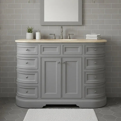 Gray bathroom vanity with wooden countertop against a gray tiled wall.