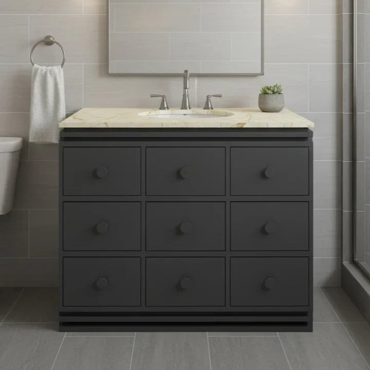 Bathroom vanity with marble countertop and sink in a modern bathroom setting.