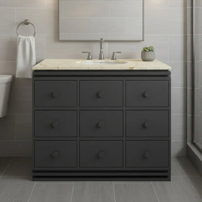 Bathroom vanity with marble countertop and sink in a modern bathroom setting.