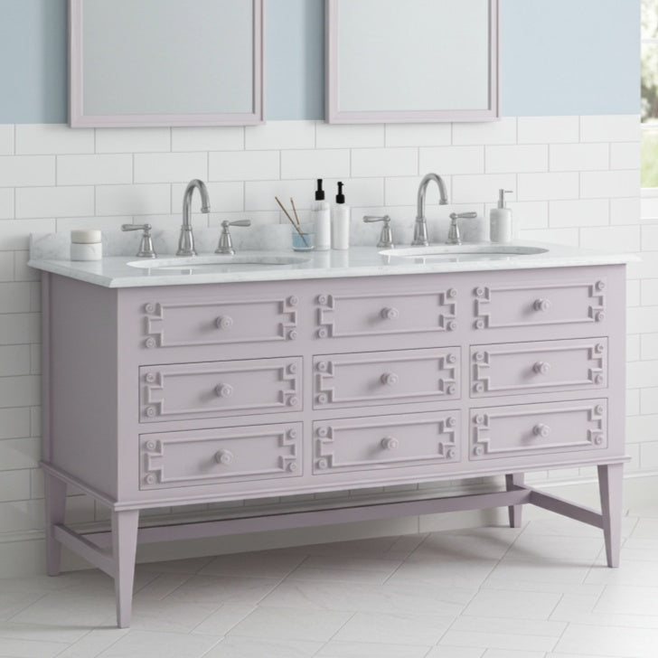 Bathroom vanity with double sink and light gray cabinets.