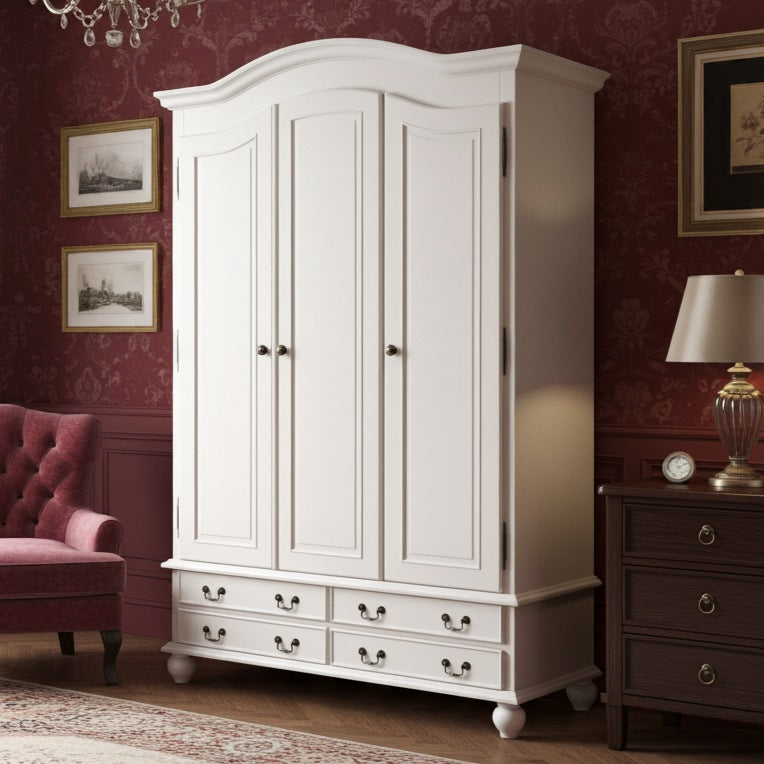 White wardrobe in a room with red walls, a pink armchair, and a lamp.
