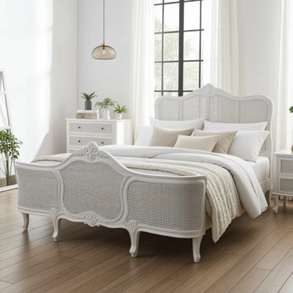 White bedroom with a decorative bed and wooden flooring