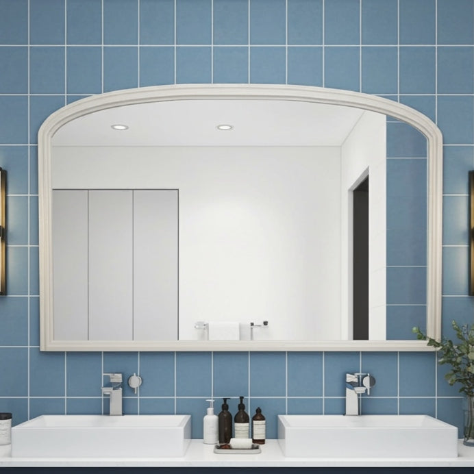 Bathroom with blue tiled walls, white sink, and large mirror.