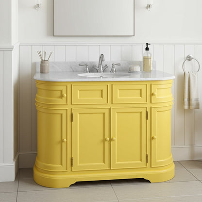 Yellow bathroom vanity with white countertop and sink in a bathroom setting.