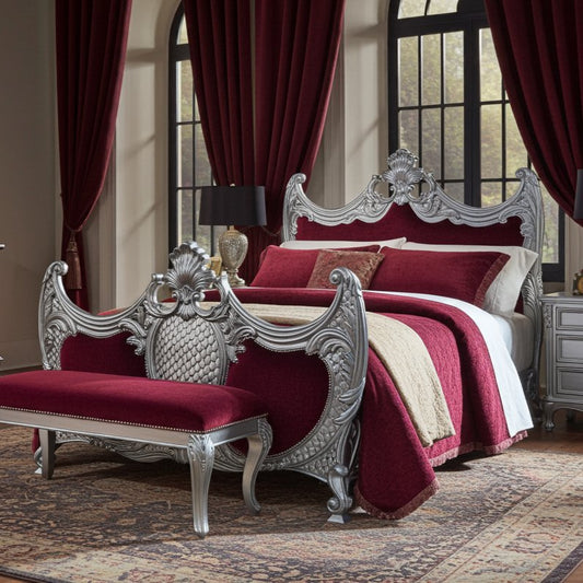 Luxurious bedroom with ornate silver bed frame and bench, red bedding, and large windows.