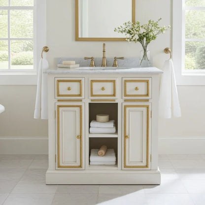 Bathroom vanity with marble countertop, gold fixtures, and decorative elements.