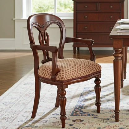 Wooden chair with patterned cushion in a room with a desk and window