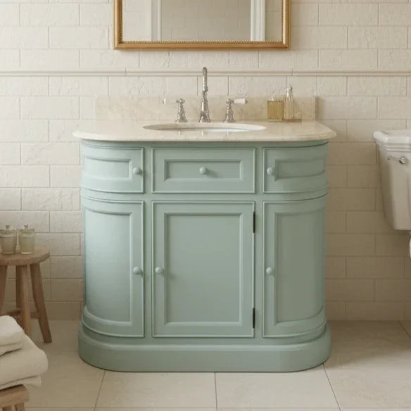 Curved bathroom vanity unit with cream marble top in bathroom setting