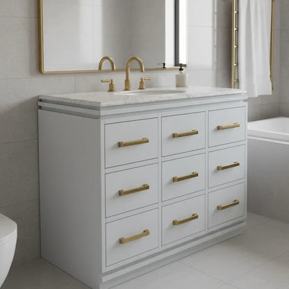 Bathroom vanity with marble countertop and gold fixtures