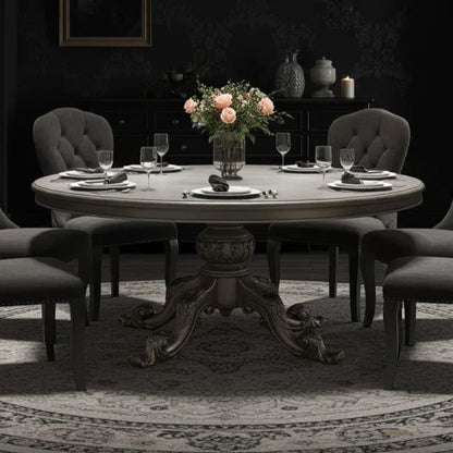large, circular, silver dining table in a dark dining room